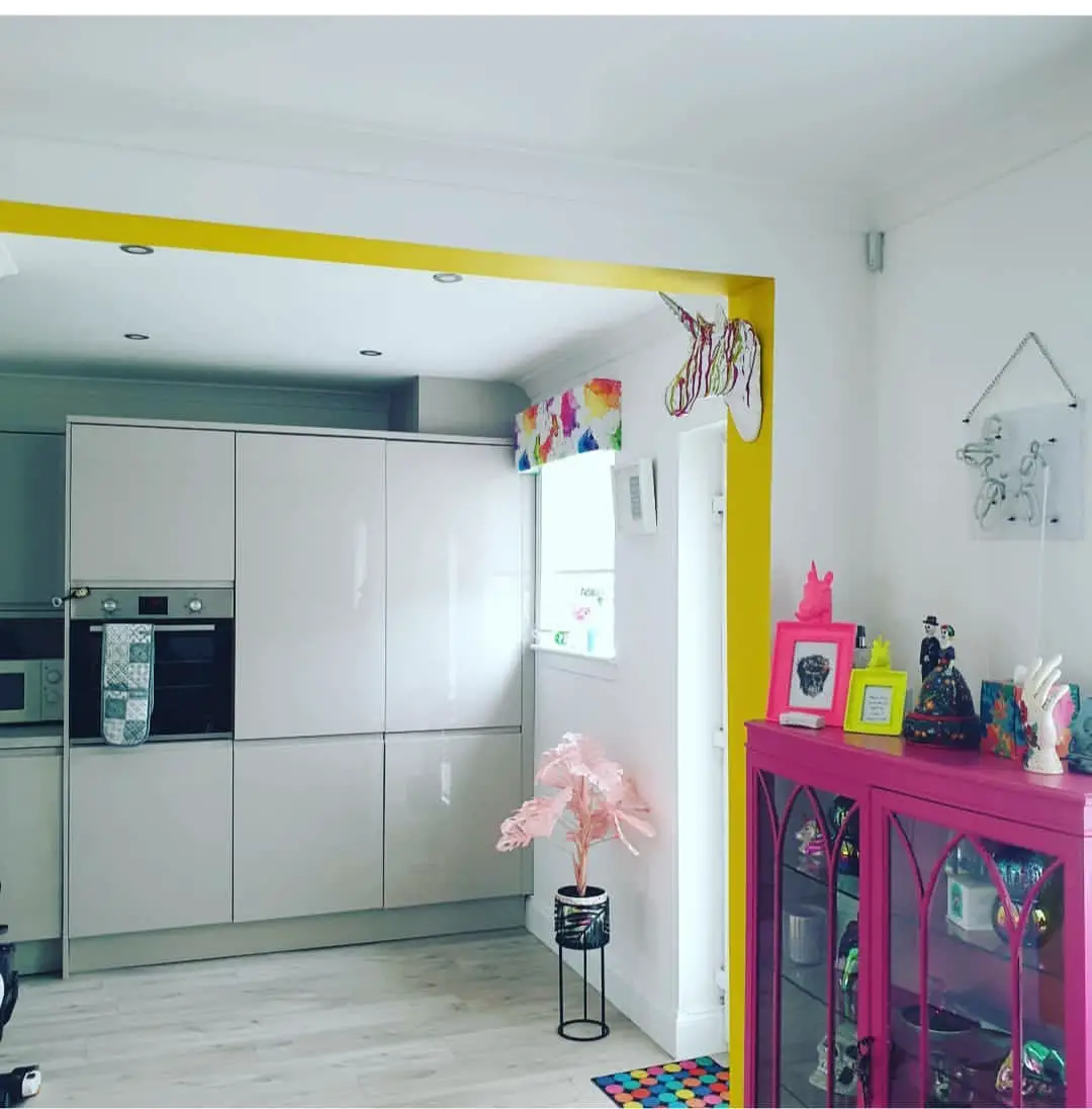 Colorful Eclectic Kitchen Area that has Pink and Yellow