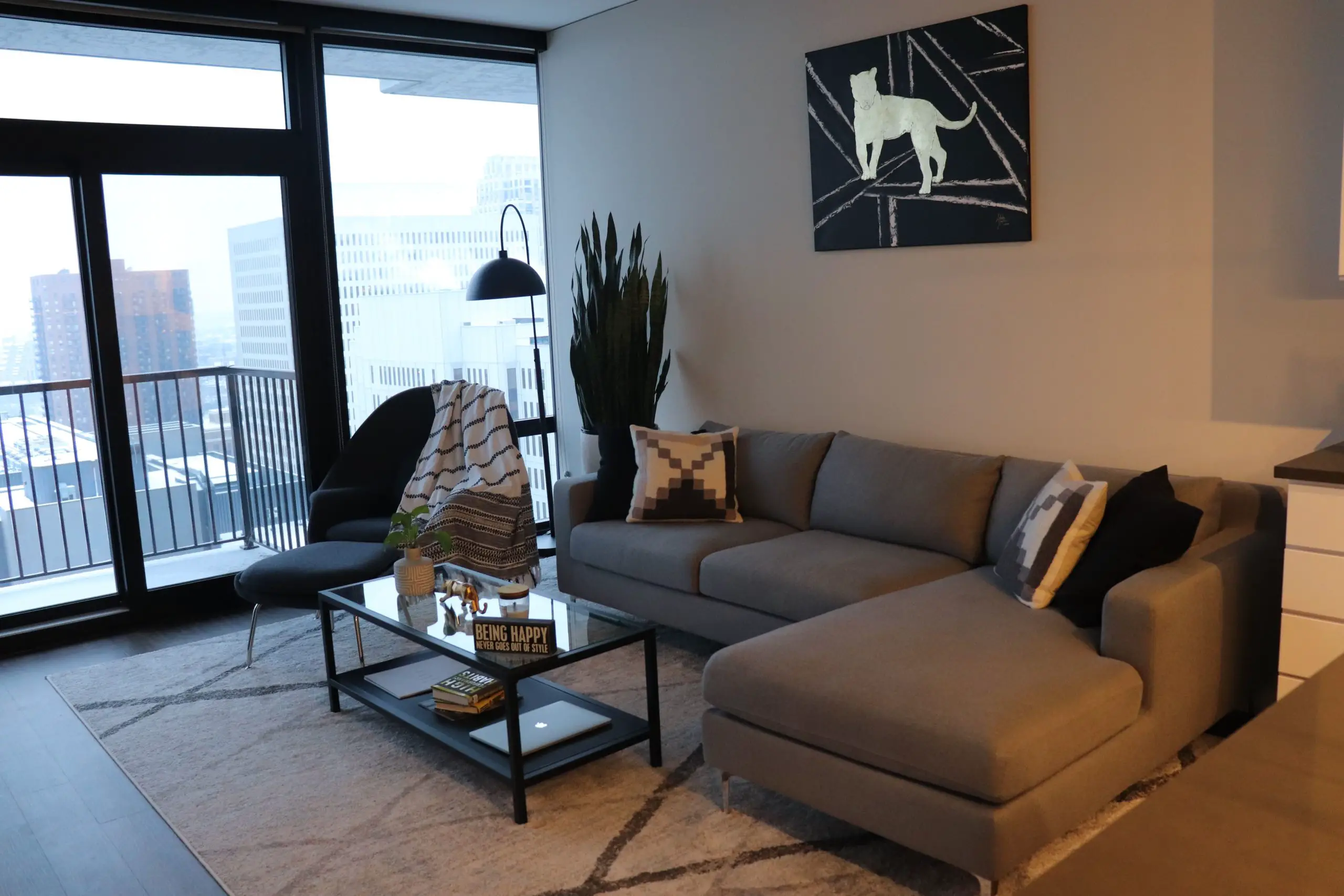 Womb Chair Gray Sectional Downtown Floor to Ceiling Windows